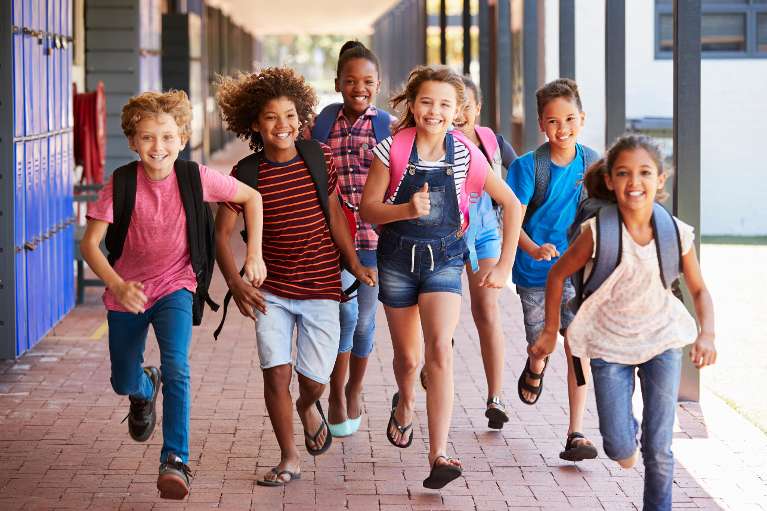group of school children running | pediatric dentist spring branch
